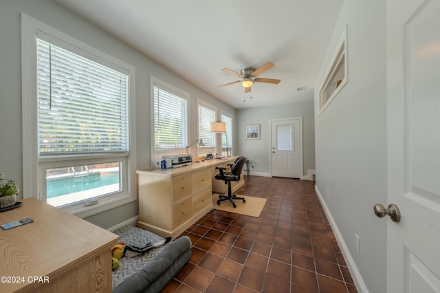 tiled office space featuring ceiling fan