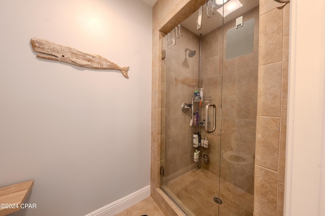 bathroom with a shower with door