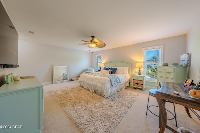 bedroom featuring ceiling fan and light carpet