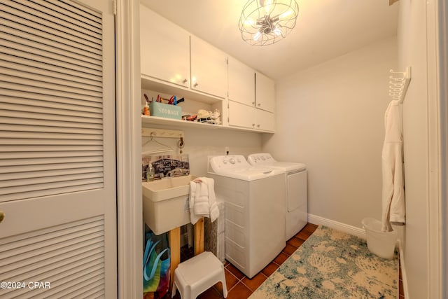 laundry area with cabinets, washer and clothes dryer, and dark wood-type flooring