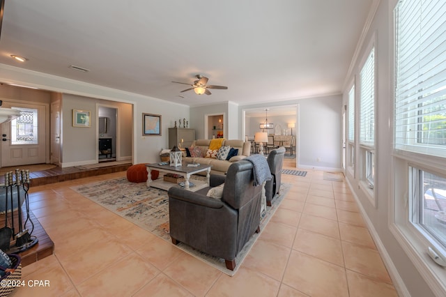 living room with crown molding, ceiling fan, and light tile patterned floors