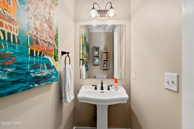 bathroom featuring toilet and crown molding