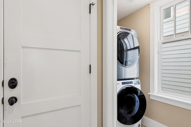 clothes washing area with stacked washer / drying machine