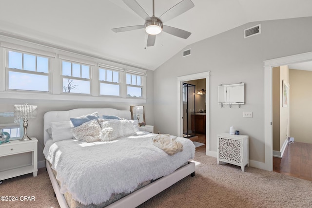 bedroom featuring ceiling fan, carpet floors, ensuite bath, and lofted ceiling