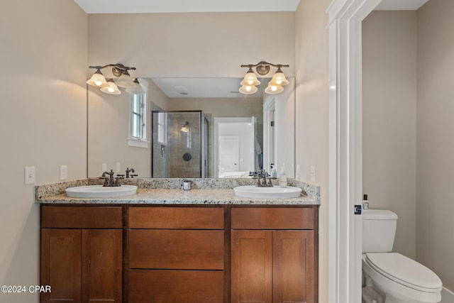 bathroom featuring toilet, an enclosed shower, and vanity