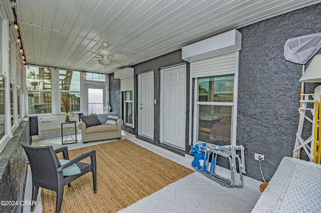 sunroom / solarium featuring ceiling fan, wooden ceiling, and a wall mounted AC