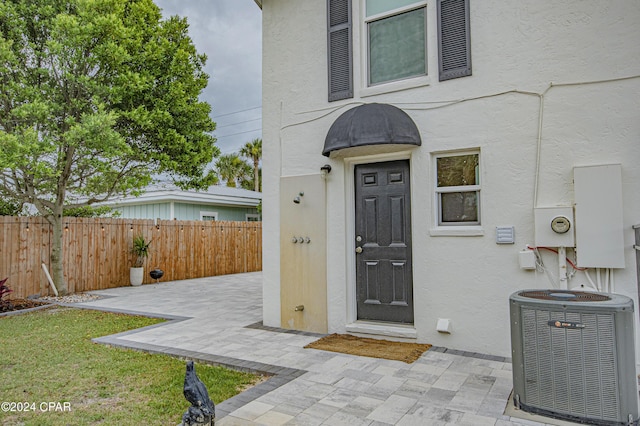 doorway to property with a patio area and cooling unit