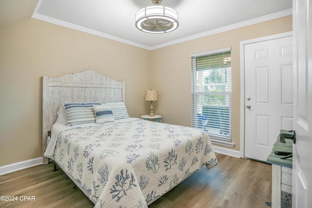 bedroom with ornamental molding and hardwood / wood-style flooring