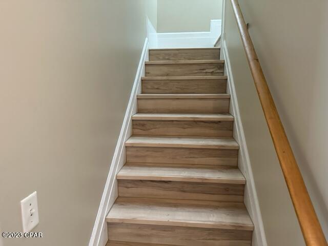 stairs featuring hardwood / wood-style flooring