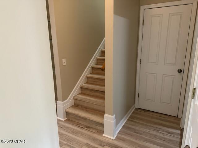 stairway with hardwood / wood-style flooring