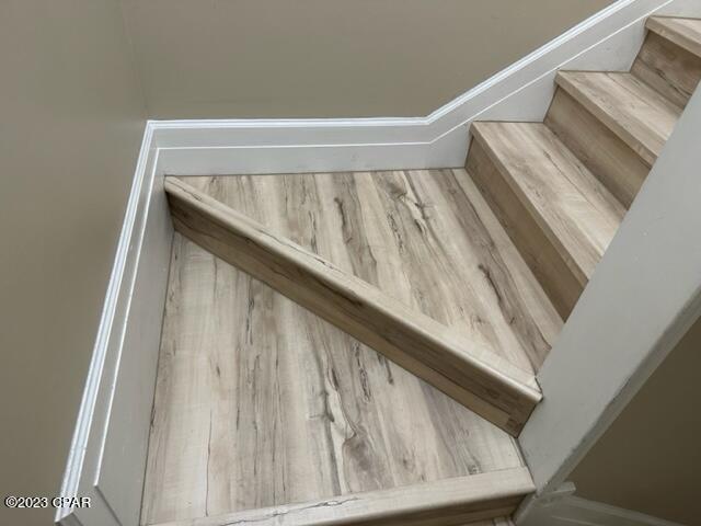 stairway featuring hardwood / wood-style flooring