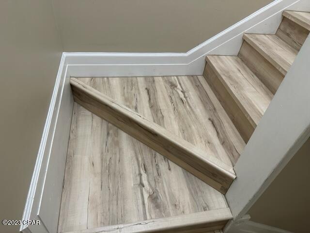 stairs featuring hardwood / wood-style floors