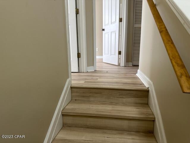 stairway with wood-type flooring