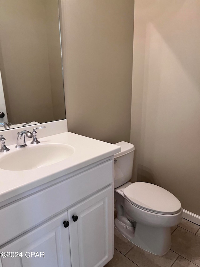 bathroom featuring vanity, toilet, and tile patterned floors