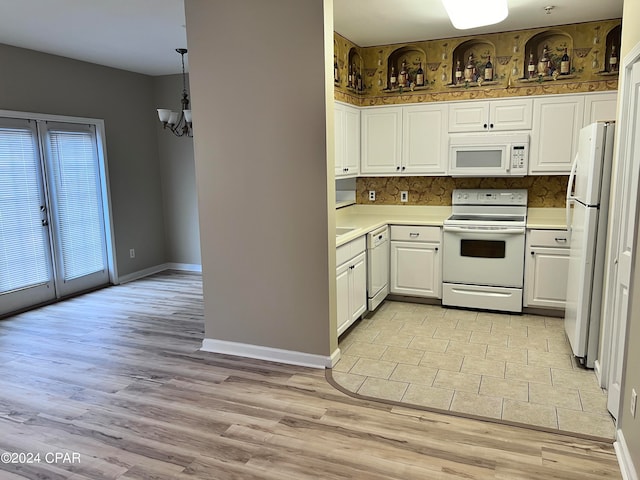 kitchen featuring hanging light fixtures, light hardwood / wood-style floors, white cabinetry, tasteful backsplash, and white appliances