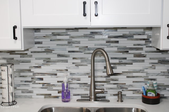 details with light countertops, a sink, and white cabinetry