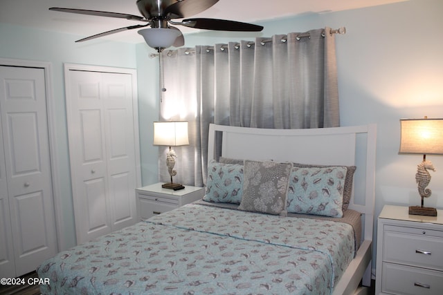 bedroom featuring ceiling fan and two closets