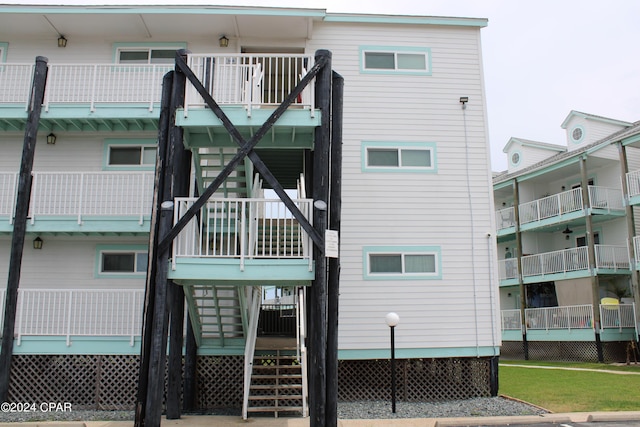 rear view of property featuring stairs