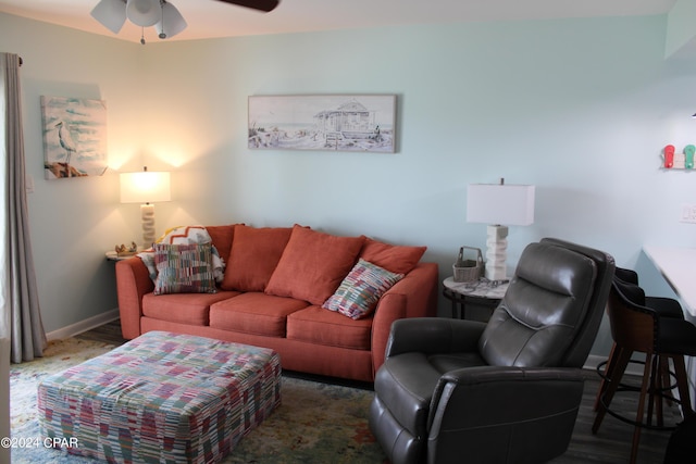 living room featuring baseboards and a ceiling fan