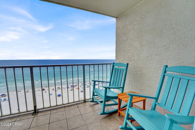 balcony featuring a water view and a view of the beach