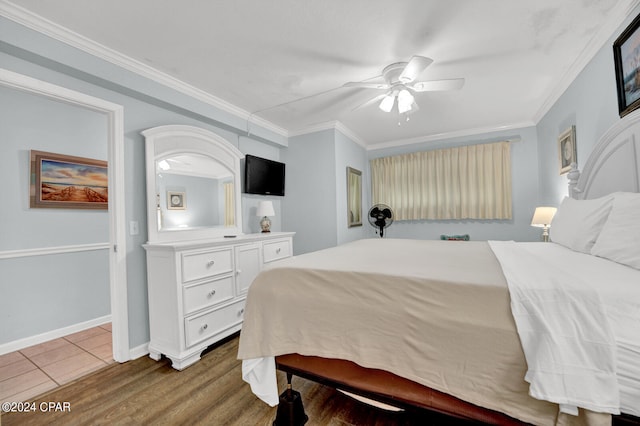 bedroom featuring ceiling fan, crown molding, and wood-type flooring