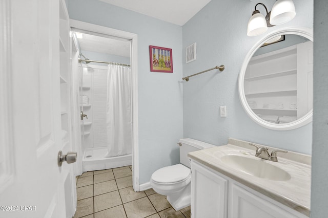 bathroom with tile patterned flooring, curtained shower, vanity, and toilet