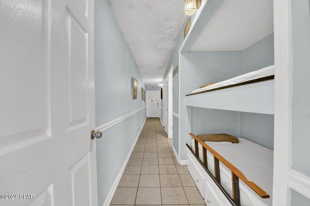 hallway featuring light tile patterned floors