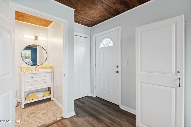 foyer featuring wood ceiling and dark hardwood / wood-style flooring