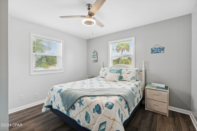 bedroom with ceiling fan and dark hardwood / wood-style flooring