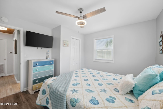 bedroom with ceiling fan, hardwood / wood-style flooring, and a closet