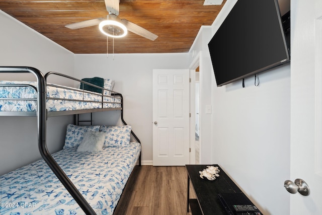 bedroom with ceiling fan, wooden ceiling, and dark hardwood / wood-style floors