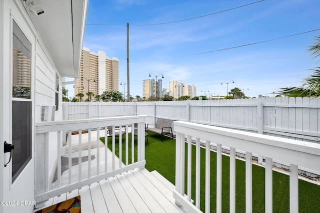 wooden deck featuring a lawn