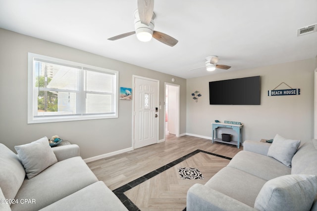 living room featuring ceiling fan and light hardwood / wood-style floors