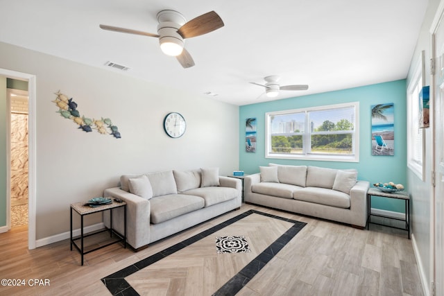 living room featuring ceiling fan and light wood-type flooring