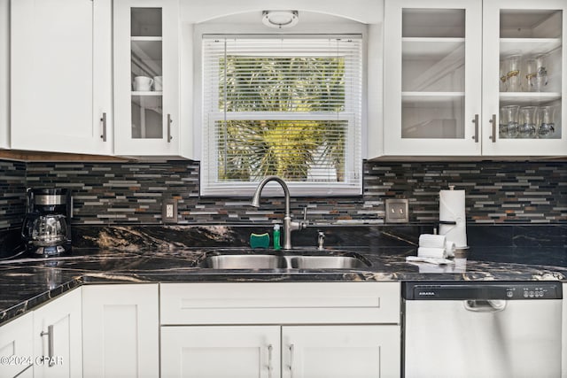 kitchen with decorative backsplash, stainless steel dishwasher, and white cabinetry