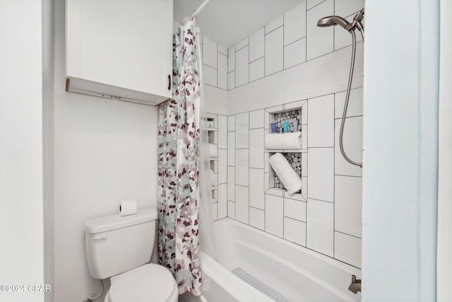 bathroom with toilet and shower / tub combo with curtain