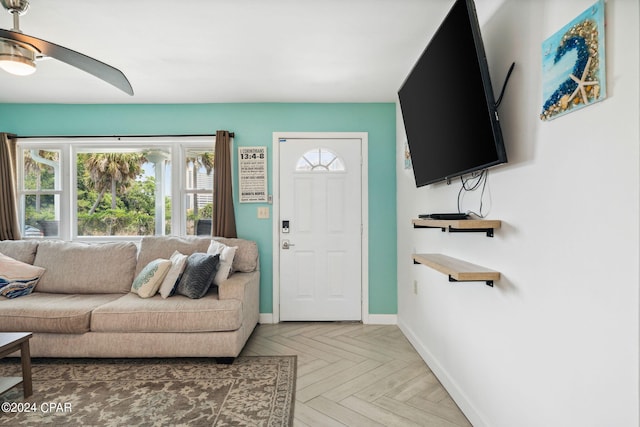 living room featuring ceiling fan and parquet flooring