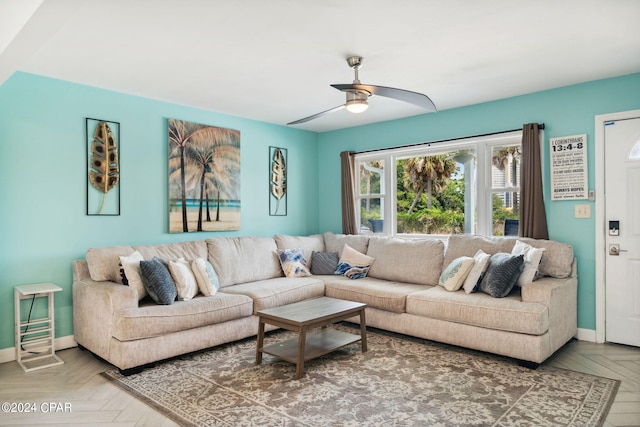 living room featuring ceiling fan and parquet flooring