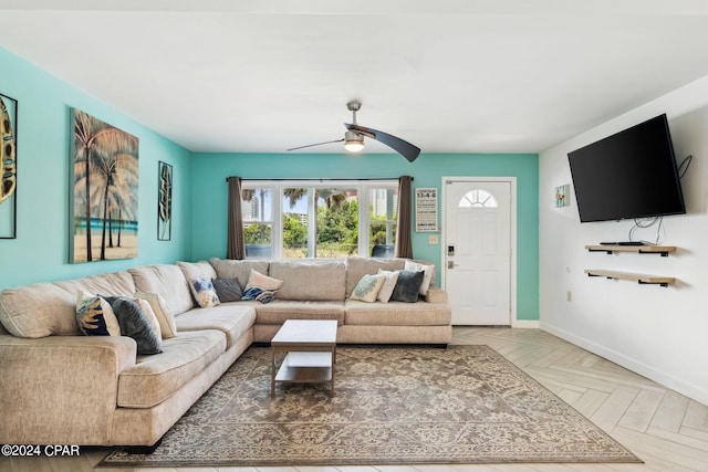 living room with ceiling fan and parquet flooring