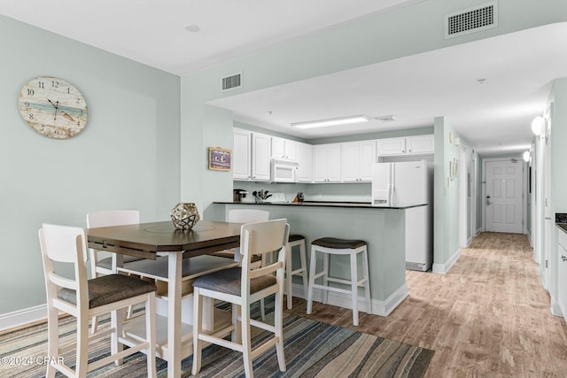 dining room with light wood-type flooring