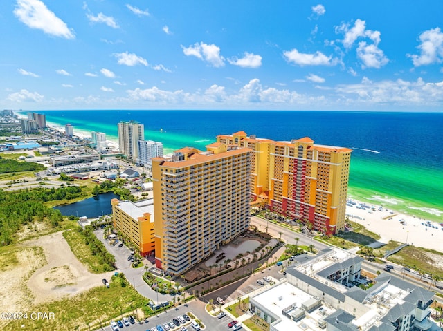 drone / aerial view with a water view and a beach view