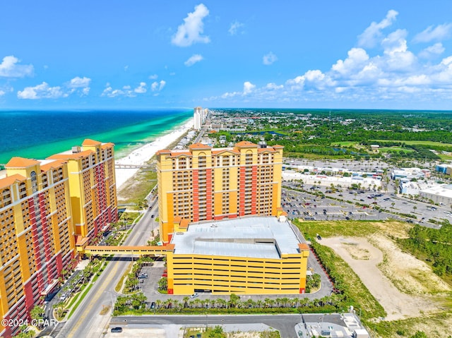 drone / aerial view featuring a beach view and a water view