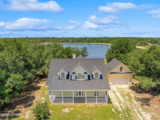 view of front of home with a garage, a water view, and a porch