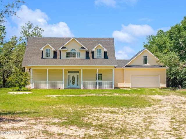 view of front of house with a garage, a front lawn, and a porch