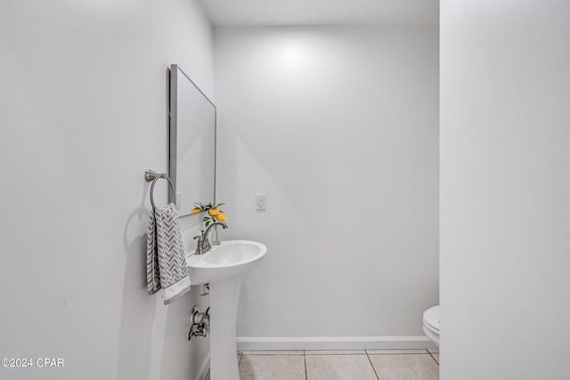 bathroom featuring tile patterned flooring and toilet