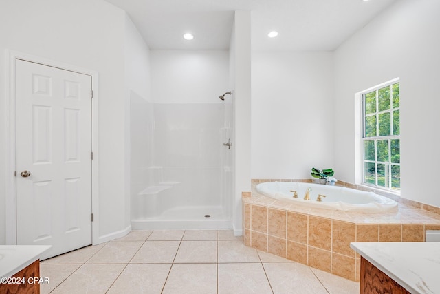 bathroom featuring tile patterned floors, independent shower and bath, and vanity