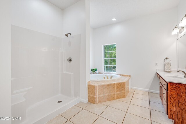 bathroom with plus walk in shower, vanity, and tile patterned floors