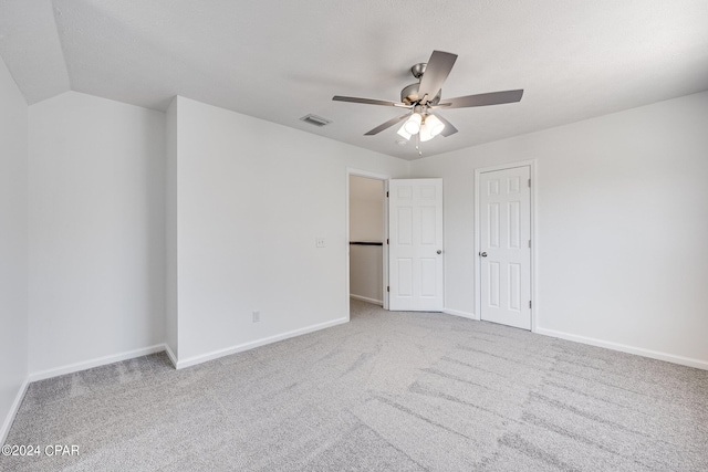 unfurnished bedroom with ceiling fan and light colored carpet