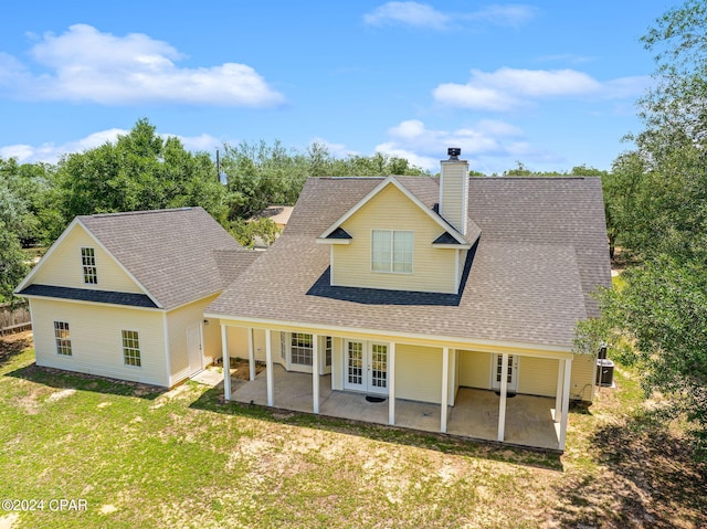 rear view of property featuring a patio area and a lawn