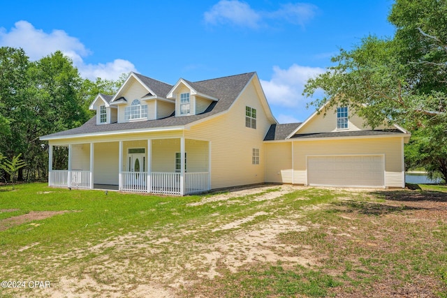 view of front of house featuring a garage, a porch, and a front lawn